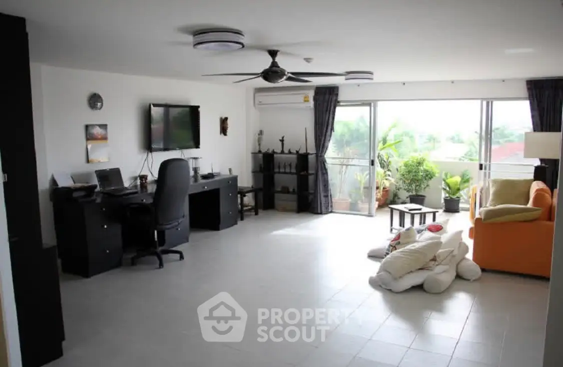 Spacious living room with balcony and modern furnishings