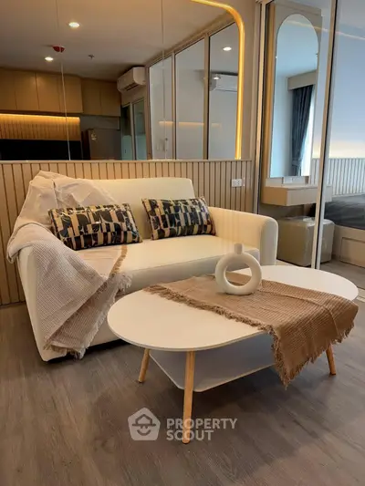 Modern living room with stylish sofa and coffee table in a cozy apartment setting.