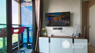 Modern living room with balcony, featuring wall-mounted TV and stylish decor.