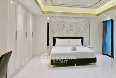 Luxurious modern bedroom with marble accent wall and sleek design