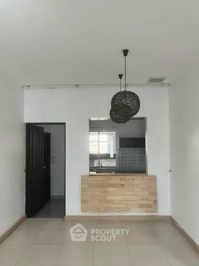 Modern minimalist kitchen with open layout and stylish pendant lights
