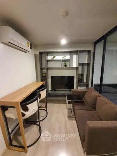 Modern living room with stylish furniture and built-in shelving, perfect for urban living.