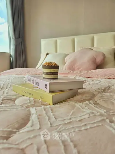 Cozy bedroom with plush bedding and books, offering a serene and inviting atmosphere.