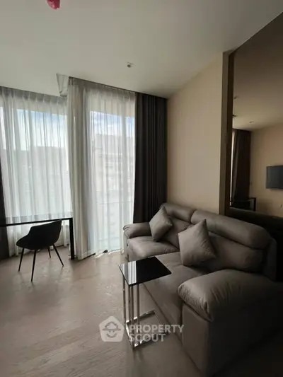 Modern living room with elegant sofa and floor-to-ceiling windows