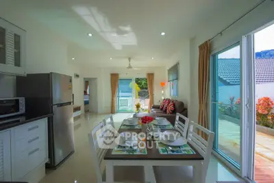 Spacious open-plan living and dining area with modern kitchen and large balcony access.