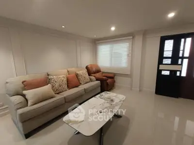 Elegant living room with cozy sofa and modern marble coffee table, perfect for relaxation and entertaining.