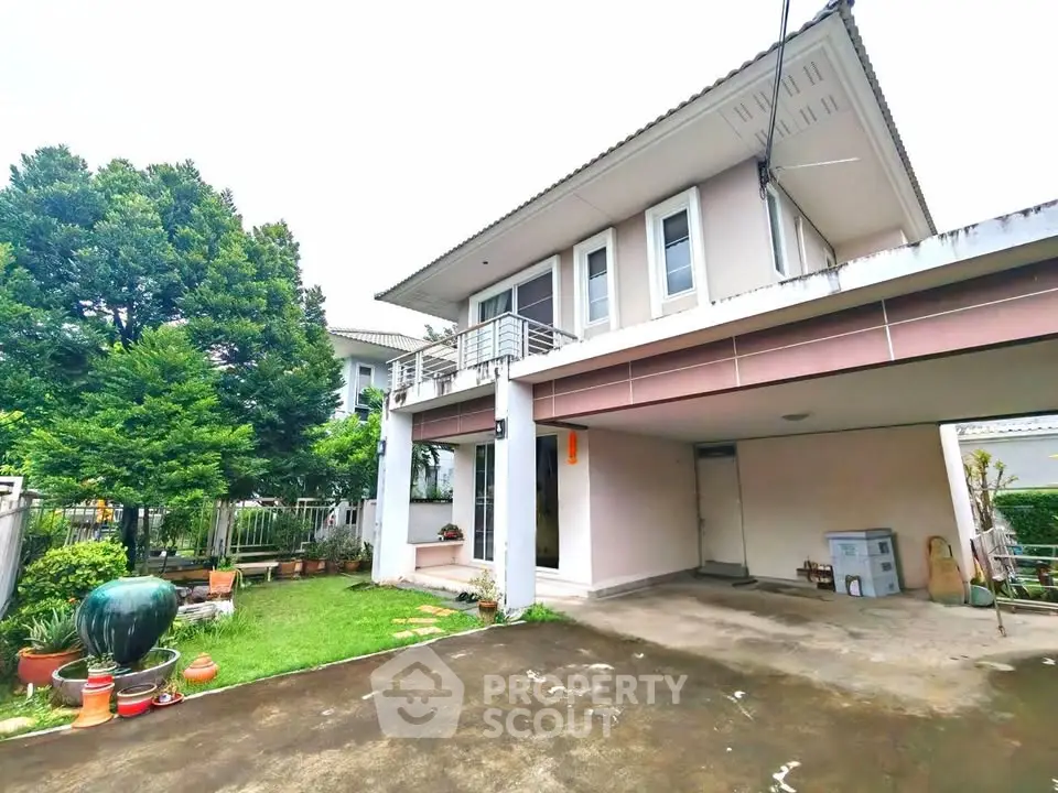 Spacious two-story house with garage and lush garden in a serene neighborhood.