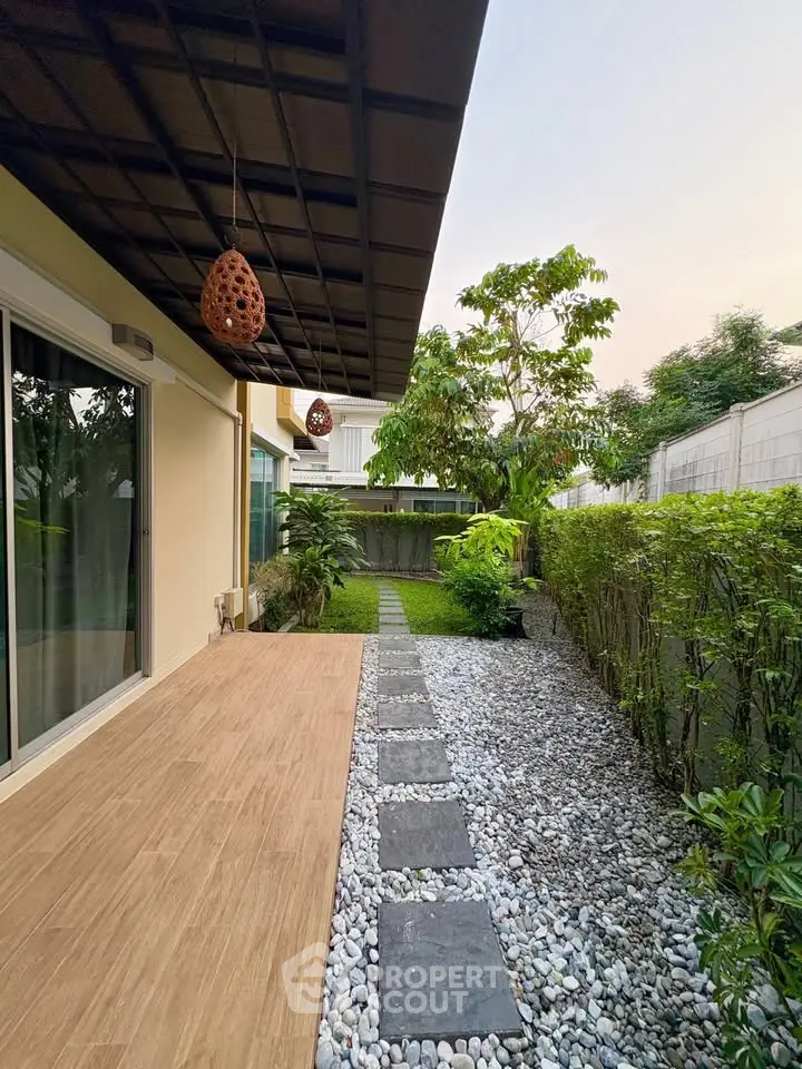 Charming garden view with modern patio and lush greenery, perfect for relaxation and outdoor enjoyment.