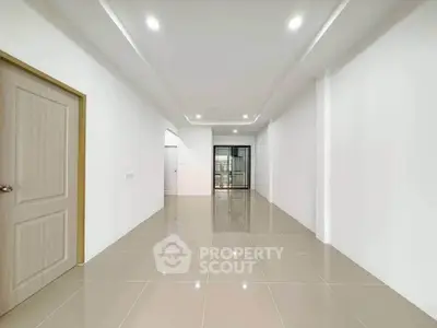 Spacious modern living room with sleek tile flooring and recessed lighting