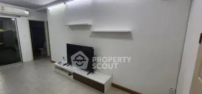 Modern living room with sleek TV setup and minimalist shelves