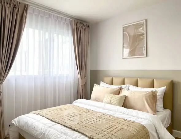 Cozy and elegant bedroom with soft beige tones and natural light