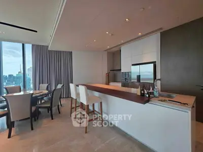 Luxurious modern kitchen with open layout and stunning city view, featuring sleek appliances and elegant dining area.