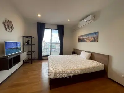 Spacious modern bedroom with city view and stylish decor