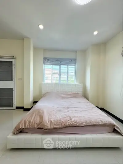 Spacious bedroom with natural light and modern decor