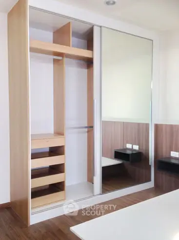 Modern bedroom with sleek built-in wardrobe and wooden flooring