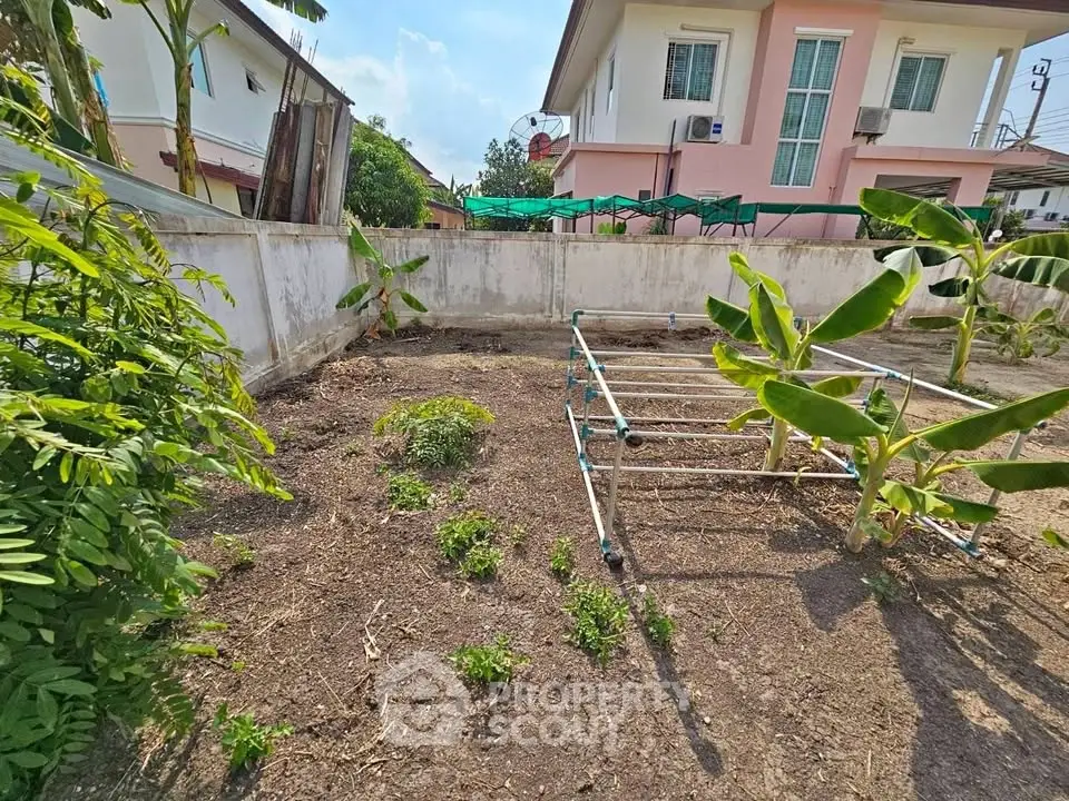 Spacious garden area with potential for landscaping in suburban residential property.