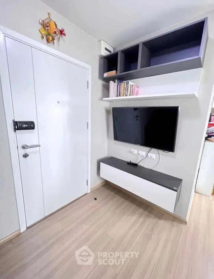 Modern living room with sleek TV setup and stylish shelving