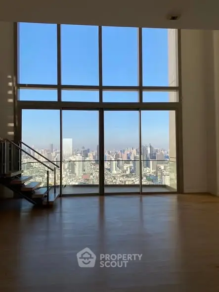 Stunning high-rise apartment with floor-to-ceiling windows offering breathtaking city views.