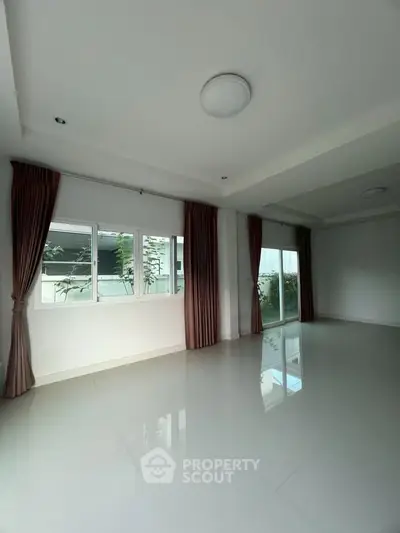 Spacious empty living room with large windows and modern design