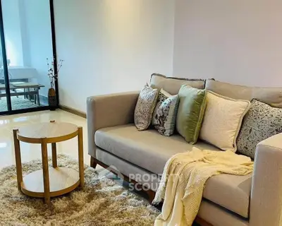 Cozy living room with stylish sofa and modern decor in a bright apartment.