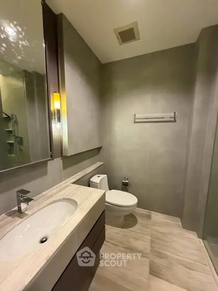 Modern bathroom with sleek fixtures and neutral tones, featuring a stylish vanity and spacious layout.