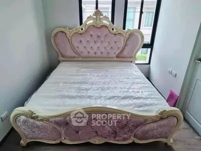 Luxurious bedroom with elegant pink velvet bed and large windows