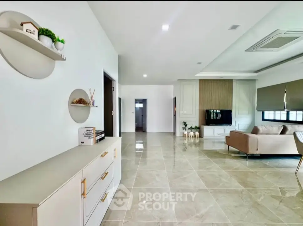 Spacious modern living room with sleek design and elegant furnishings.