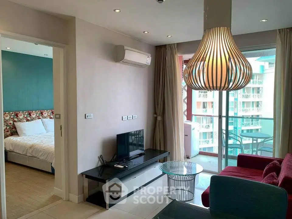 Modern living room with stylish lighting and balcony view in a cozy apartment.