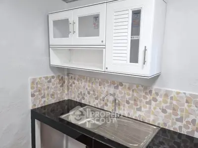 Modern kitchen with sleek cabinetry and stainless steel sink