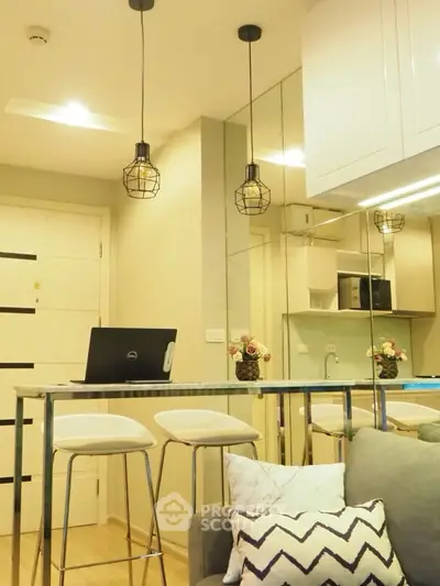 Modern kitchen with stylish lighting and breakfast bar seating