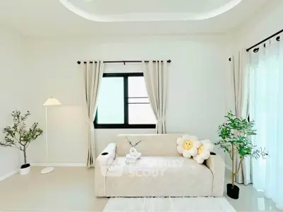 Bright and airy living room with modern decor and cozy sofa.