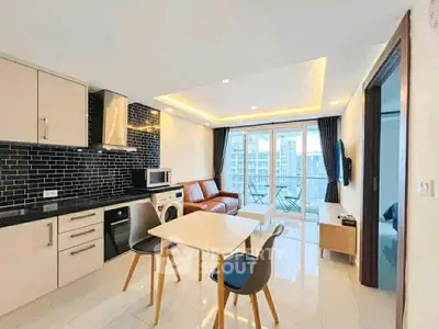 Modern open-plan living room with sleek kitchen and city view balcony.