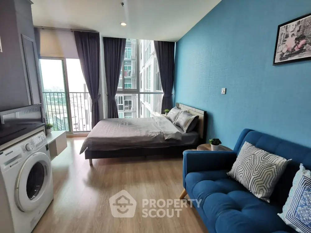 Modern bedroom with balcony and washing machine in stylish apartment