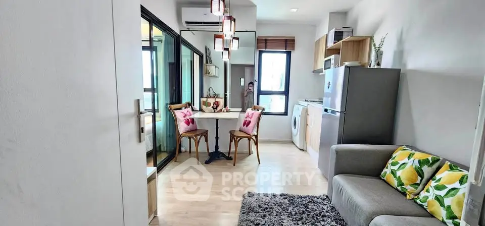 Modern apartment interior with cozy living area and stylish kitchen appliances.