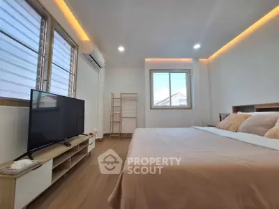 Spacious bedroom with modern decor and natural light