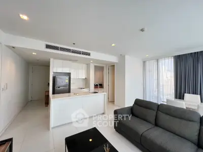 Modern open-plan living room with sleek kitchen and stylish furnishings