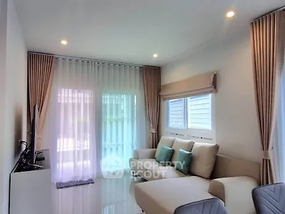 Modern living room with elegant curtains and cozy seating area