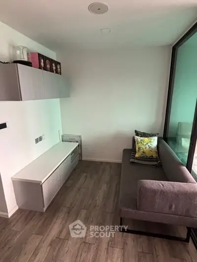Modern living room with sleek furniture and large window for natural light.