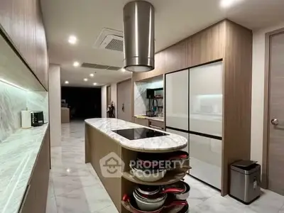 Modern kitchen with sleek marble countertops and integrated appliances