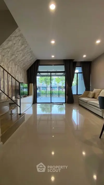 Spacious modern living room with large windows and elegant decor