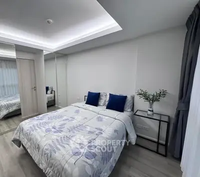 Modern bedroom with mirrored closet and stylish decor