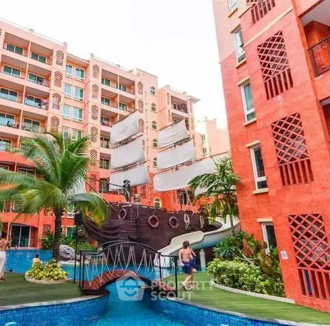 Vibrant apartment complex with unique pirate ship pool feature.