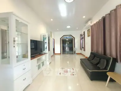 Spacious living room with modern decor and ample natural light