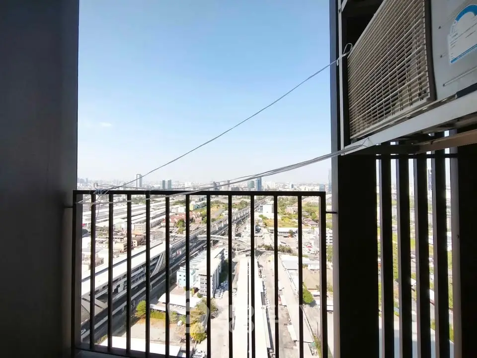 Stunning cityscape view from a high-rise balcony with air conditioning unit.