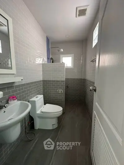 Modern bathroom with sleek gray tiles and compact design