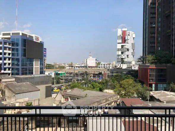 Stunning urban cityscape view from a balcony showcasing modern architecture and vibrant skyline.