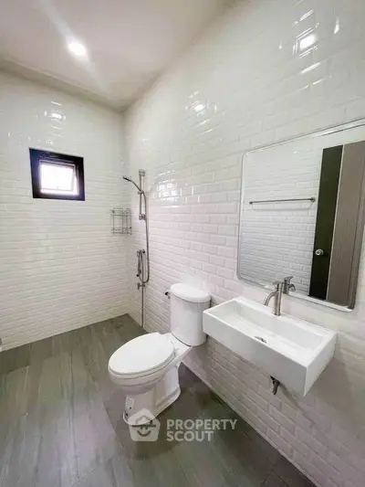 Modern bathroom with sleek white tiles and contemporary fixtures