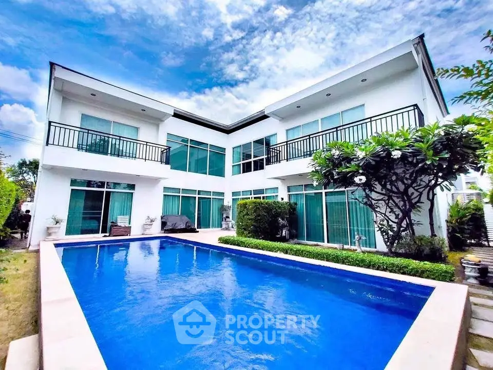 Stunning modern villa with pool and lush garden, perfect for luxury living.