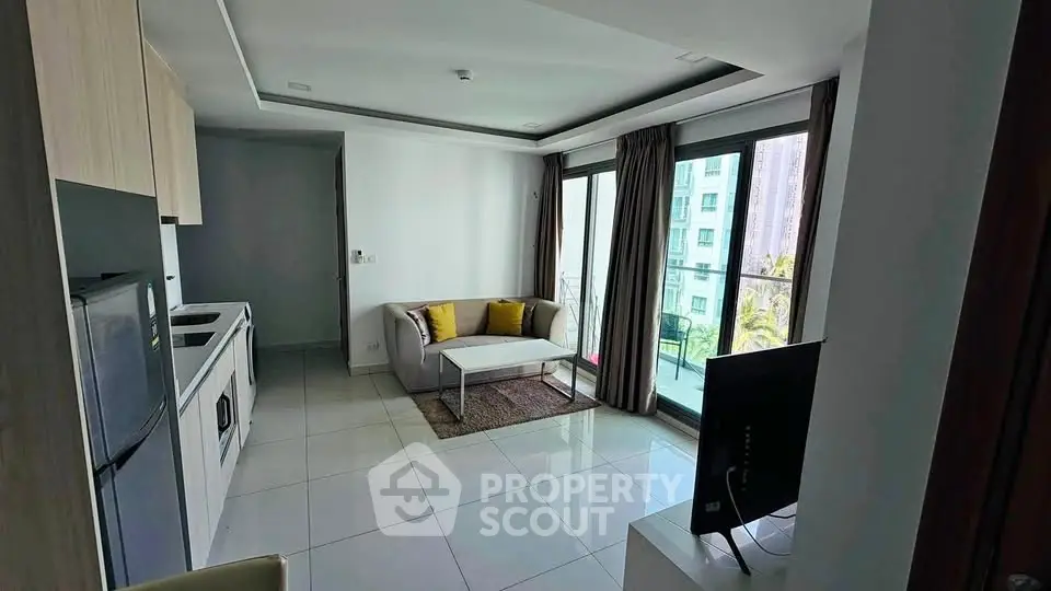 Modern apartment living room with open kitchen and balcony view