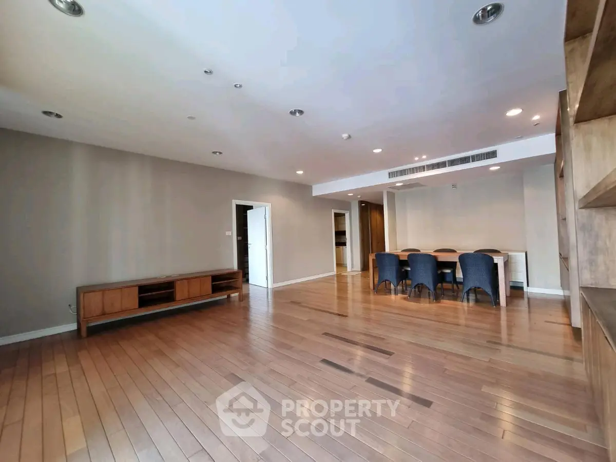 Spacious modern living room with wooden flooring and elegant dining area